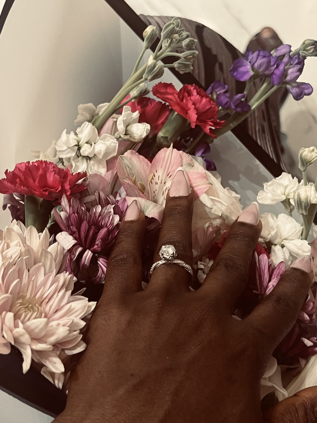 The engagement ring resting among flowers